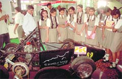 Schoolchildren look at the model of a vehicle displayed at PEC University of Technology in Chandigarh on Saturday.