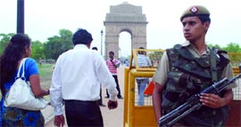 A Delhi policeman keeps a vigil at the India Gate in New Delhi on Saturday after the US embassy warned of terrorist attacks