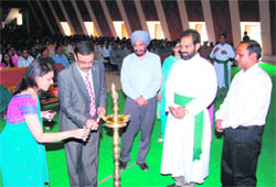 Dr Gaurav Luthra lights the lamp at St Josephs Academy in Dehradun 