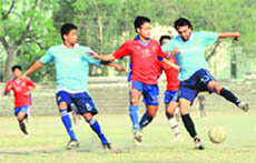 Players vie for the ball during a match at the RB Singh Memorial Football Tournament in Dehradun