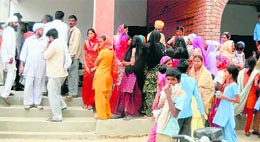 Villagers assemble in Primary School at Harni Khurd on Saturday, demanding action against the teacher accused of molesting schoolgirls at Dharampura 