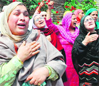 Relatives of Shafiq Ahmed Sheikh, who died after one of the stones thrown by protesting youths hit him in the head on Friday, wail inconsolably in Srinagar