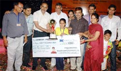 Arshia Thakral accompanied by her parents while receiving the Champions Trophy in a state-level mental arithmetic test held at Mohali. 