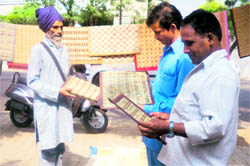 Manohar Singh (in turban) sells chiks in Dehradun on Sunday. A Tribune photograph