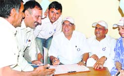 Haryana Chief Minister Bhupinder Singh Hooda checks the details collected during a census programme in Ulhawas village of Gurgaon on Sunday.