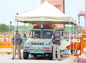 A police jeep is parked under a makeshift tent while security personnel guard the India Gate in New Delhi on Sunday. Security has been beefed up in and around Delhi in the wake of terror threats. The US Embassy says terrorists are planning imminent attacks in India's capital and warns Americans to be vigilant.