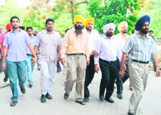 Jagdish Singh Daad (in white shirt and white turban), relative of Bharat Inder Singh Chahal, and Harjinder Singh (extreme left) are taken to the court by Vigilance Bureau sleuths in Ludhiana on Sunday.
