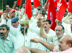 Members of the All-India Road Transport Workers Federation demonstrate for their demands at Jantar Mantar in New Delhi on Monday.
