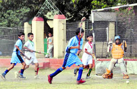 Players vie for the ball at the Inter-Council School Sub-Junior Boys Hockey Tournament in Dehradun on Monday