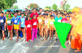 Mahamandaleshwar Soham Baba flags off the mini-marathon organised to mark the World Athletics Week in Dehradun on Monday. A Tribune photograph
