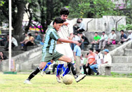 A match in progress at the RB Singh Memorial Football Tournament in Dehradun on Monday. A Tribune photograph 