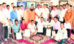 Officials of the mela administration after being honoured by Mahnirmani Akhada in Haridwar on Sunday. 