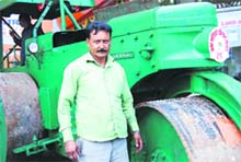 Masoom with the 100-year-old road roller in Mussoorie