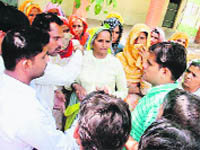 Residents of Mandhiya Khurd village in Rewari hold a protest against poor water supply on Monday. 
