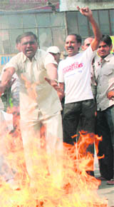  Members of the Dalit community burn the effigy of Gujarat Chief Minister Narendra Modi in Karnal on Monday.