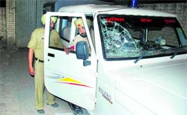 The police vehicle damaged by the youths.