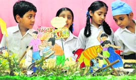 Students of Guru Nanak Public School look at a model in Ludhiana on Monday.