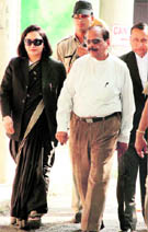 Former Haryana DGP SPS Rathore leaves the District Courts premises with his counsel-wife Abha Rathore in Chandigarh on Monday