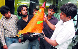 Students of Dr B.R. Ambedkar National Institute of Technology (NIT) show their robot for saloon cleaning in Jalandhar on Tuesday