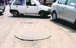 The raised manholes are a traffic hazard in Ludhiana.