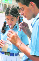 Students drink chilled lemonade to beat the heat in Ludhiana on Tuesday.