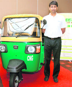 Rajiv Bajaj, managing director, Bajaj Auto Limited, poses with a three wheeler at its launch in New Delhi on Wednesday.