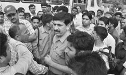 Roadways staff protest against the slapping of one of the bus conductors by a Home Guard jawan near the BSNL chowk in Panchkula on Wednesday.