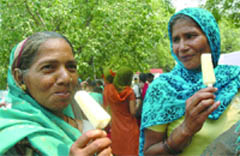 Anganwadi workers relish ice cream on a hot summer day in New Delhi 