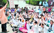 Students of the Rishikul Ayurvedic College protest in front of the college;