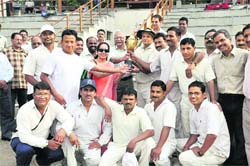The Survey of India team receive the trophy after winning the Central Government Employees Coordination Committee Cricket Tournament in Dehradun on Wednesday. 