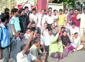 Parents hold a protest in front of Indian Cambridge School in Dehradun on Wednesday.