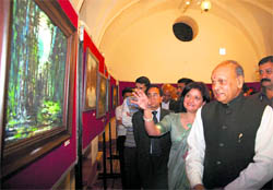Chief Minister PK Dhumal inaugurates a painting exhibition by artist Punam Gupta at Gaiety Theatre in Shimla on Wednesday. 