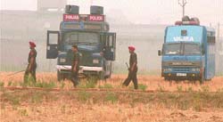 Policemen at the disputed site in Gadaipur village on Wednesday. 