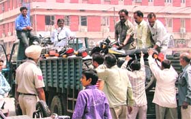 Employees of the tehbaazari wing of the Municipal Corporation remove two-wheelers outside the AC market in Ludhiana