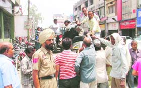 Employees of the tehbaazari wing of the Municipal Corporation remove two-wheelers outside the AC market in Ludhiana