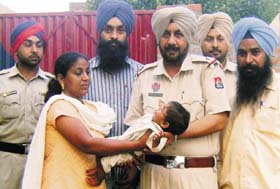 SGB International Foundation president Jasbir Kaur takes the possession of the abandoned girl child from the police at Jagroan
