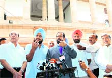 IOA president Suresh Kalmadi, secretary-general Randhir Singh and Archery Association of India president Vijay Kumar Malhotra address mediapersons in New Delhi on Wednesday.