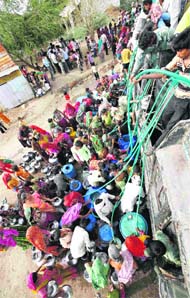 Villagers collect drinking water from a water tanker at Barara village, about 225 kmfrom Ahmedabad.