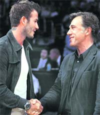 British soccer player David Beckham (L) shakes hands with Academy Awards winning actor Christoph Waltz as they meet court side at the Los Angeles Lakers basketball game of the NBA Western Conference semi-final playoff series in Los Angeles