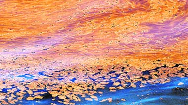 Oil blobs and oil sheen are seen in the waters of Chandeleur Sound, La. Cleanup and containment of a massive oil slick resumed on Tuesday as winds eased in the Gulf of Mexico. 