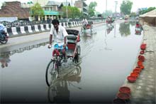 A rickshaw wades through a puddle that came up after the showers in Bathinda on Thursday. The rain brought relief to the residents from the searing heat.