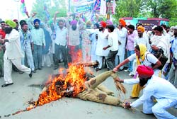 Members and activists of the Lok Janshakti Party burning effigies of two SHOs of Bathinda police on Thursday. 