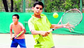 Rohit Kumar plays a shot during the semifinal match at the Chandigarh Lawn Tennis Association in Chandigarh. on Thursday.