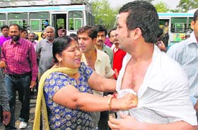 A woman caught hold of a man from his shirt and attacked him in full public view after their cars narrowly missed a collision on the road dividing Sectors 29 and 31 in Chandigarh on Thursday.