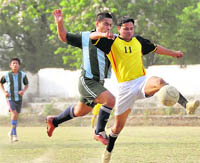 Two players vie for the ball at the RB Singh Memorial Football Tournament in Dehradun on Thursday.