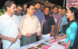 Visitors at a stall of an education fair held in Dehradun