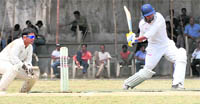 A batsman plays a shot during the All-India Uttarakhand Gold Cup Cricket Tournament in Dehradun