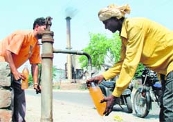 Residents draw contaminated water from a hand-pump installed near Chadha Estate in Randhawa village on the Hoshiarpur-Dasuya road on Wednesday.
