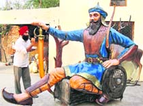 Manjit Singh gives the finishing touches to a statue of Baba Banda Singh Bahadur in a village near Moga. 
