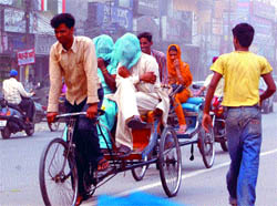 A man uses his wifes chunni to cover his face during a duststorm in Amritsar